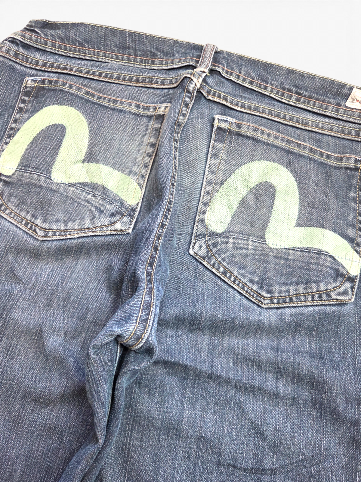 Evisu dark wash painted logo jeans, waistband and label detail